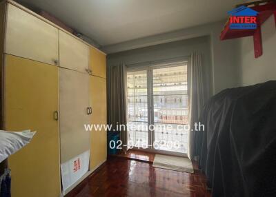 Bedroom with large wardrobe and a balcony view