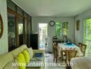 Living room and dining area with large windows and sofa