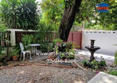 Peaceful garden with seating area and fountain