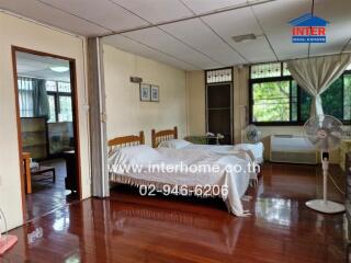 Spacious bedroom with twin beds and wooden flooring