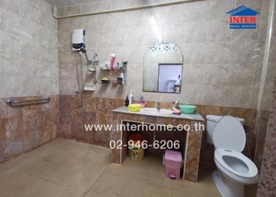 Bathroom with sink, toilet, and shower area