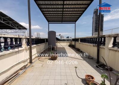 Outdoor rooftop terrace with covering and city view