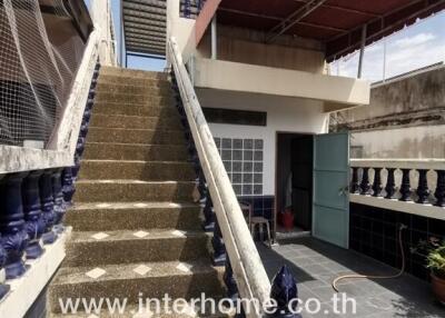 Outdoor staircase leading to the rooftop with a small room