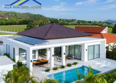 Modern house with solar panels and swimming pool in scenic location