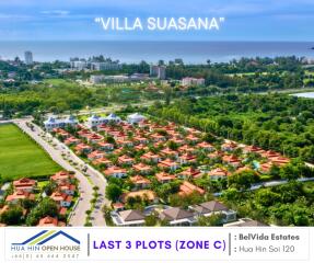 Aerial view of a residential area with red-roofed houses and greenery