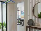 View of a hallway with a small console table and a doorway leading to another room