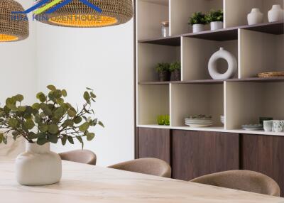 Modern kitchen dining area with open shelving and hanging lights