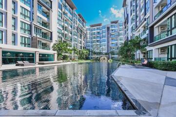 Modern residential building with a large outdoor swimming pool