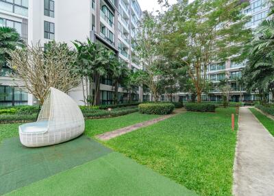 Exterior view of modern apartment complex with landscaped garden