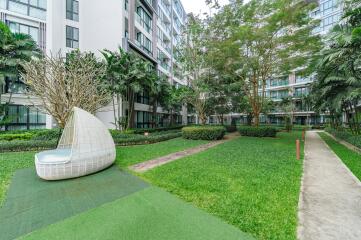 Exterior view of modern apartment complex with landscaped garden