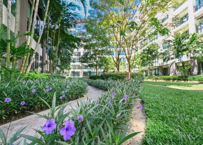 Modern residential building with lush green landscaping