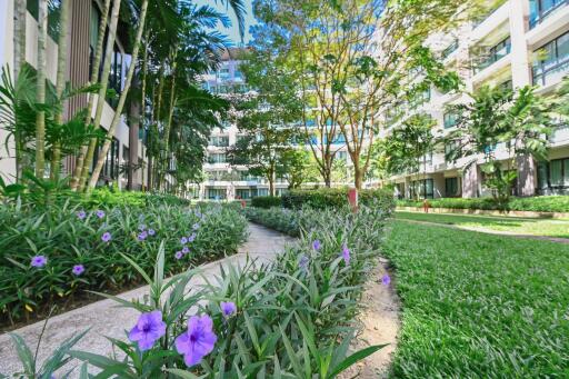 Modern residential building with lush green landscaping