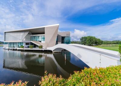 Modern waterfront house with unique architectural design and bridge