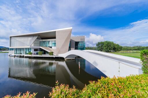 Modern waterfront house with unique architectural design and bridge