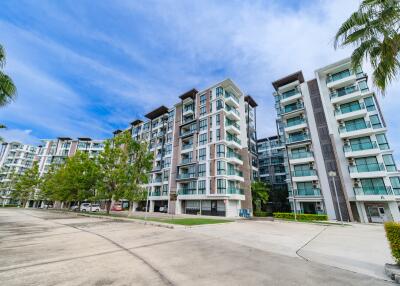 Modern apartment buildings with palm trees and clear blue sky