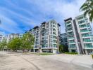 Modern apartment buildings with palm trees and clear blue sky