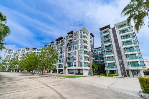 Modern apartment buildings with palm trees and clear blue sky