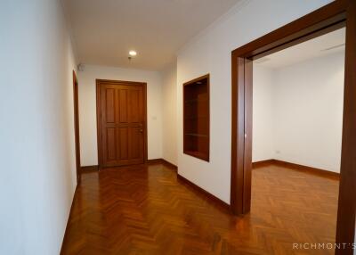 Hallway with wooden doors and parquet flooring