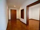 Hallway with wooden doors and parquet flooring