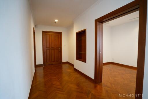 Hallway with wooden doors and parquet flooring