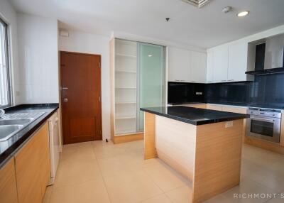 Well-lit modern kitchen with wooden cabinetry and island