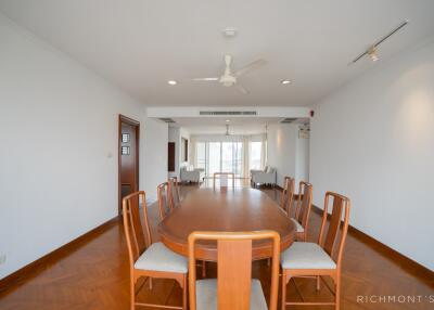 Spacious dining area with a wooden table and chairs