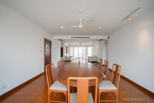 Spacious dining area with a wooden table and chairs