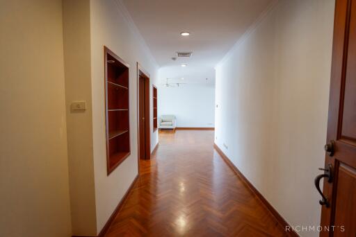 Bright hallway with wooden floors and built-in shelves