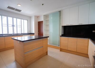 Modern kitchen with ample natural light and island