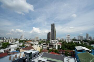 Cityscape view with tall buildings and cloudy sky