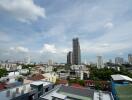 Cityscape view with tall buildings and cloudy sky