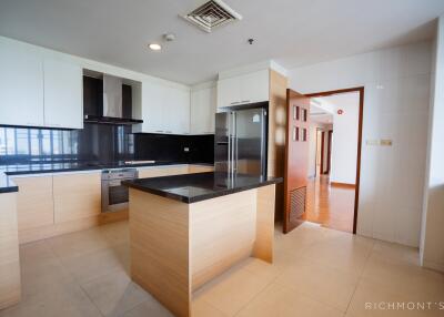 Modern kitchen with wooden cabinets and black countertops