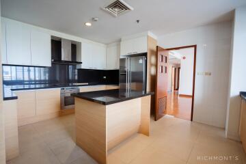 Modern kitchen with wooden cabinets and black countertops