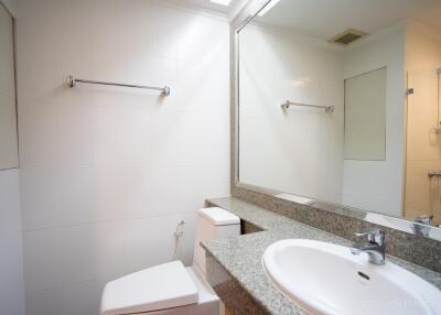 Clean and modern bathroom with granite countertop and large mirror