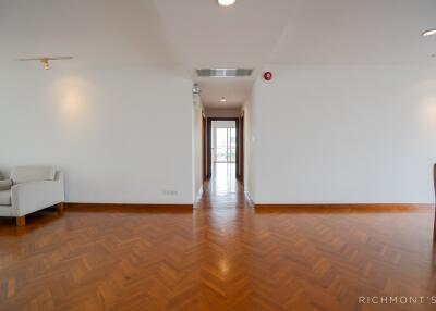 Spacious light-filled living area with wooden parquet flooring