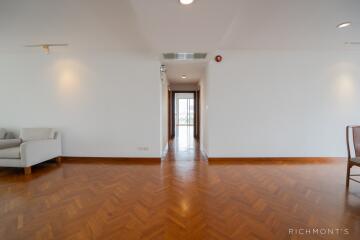 Spacious light-filled living area with wooden parquet flooring