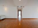 Spacious light-filled living area with wooden parquet flooring