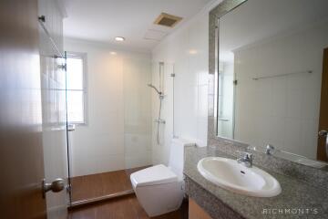 Modern bathroom with glass shower and granite countertop