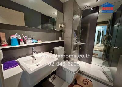 Modern bathroom with shower, sink, and toilet