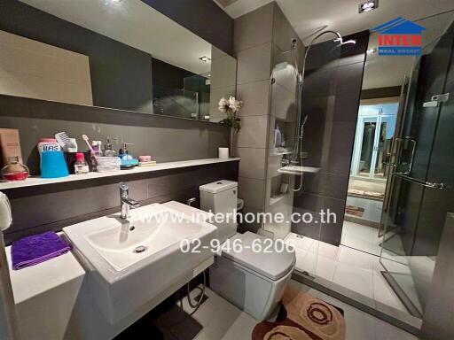 Modern bathroom with shower, sink, and toilet