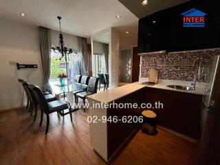 Modern kitchen and dining area with chandelier and large windows