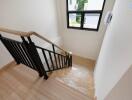 Indoor staircase with wooden steps and black railing