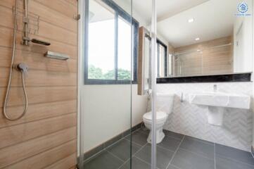 Modern bathroom with glass shower enclosure and large window