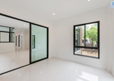 spacious living area with large windows and sliding glass doors