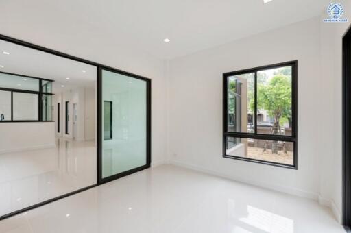 spacious living area with large windows and sliding glass doors