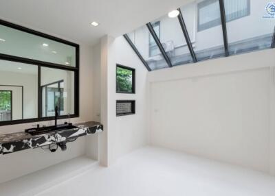 Modern room with large windows and a marble sink