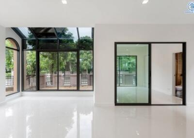 Spacious living room with large windows and sliding glass doors