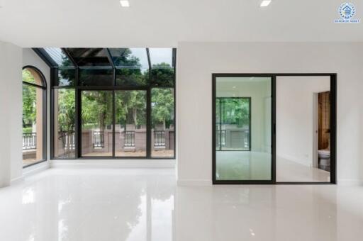 Spacious living room with large windows and sliding glass doors