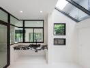 Modern kitchen with marble countertops and large windows