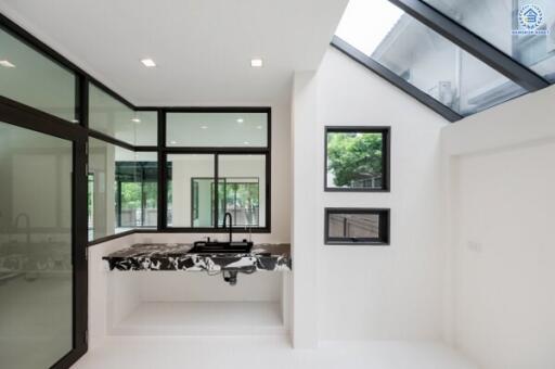 Modern kitchen with marble countertops and large windows